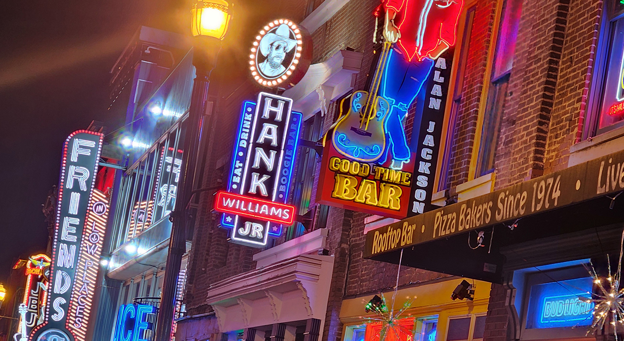 Broadway in Nashville with neon signs of celebrity-owned bars