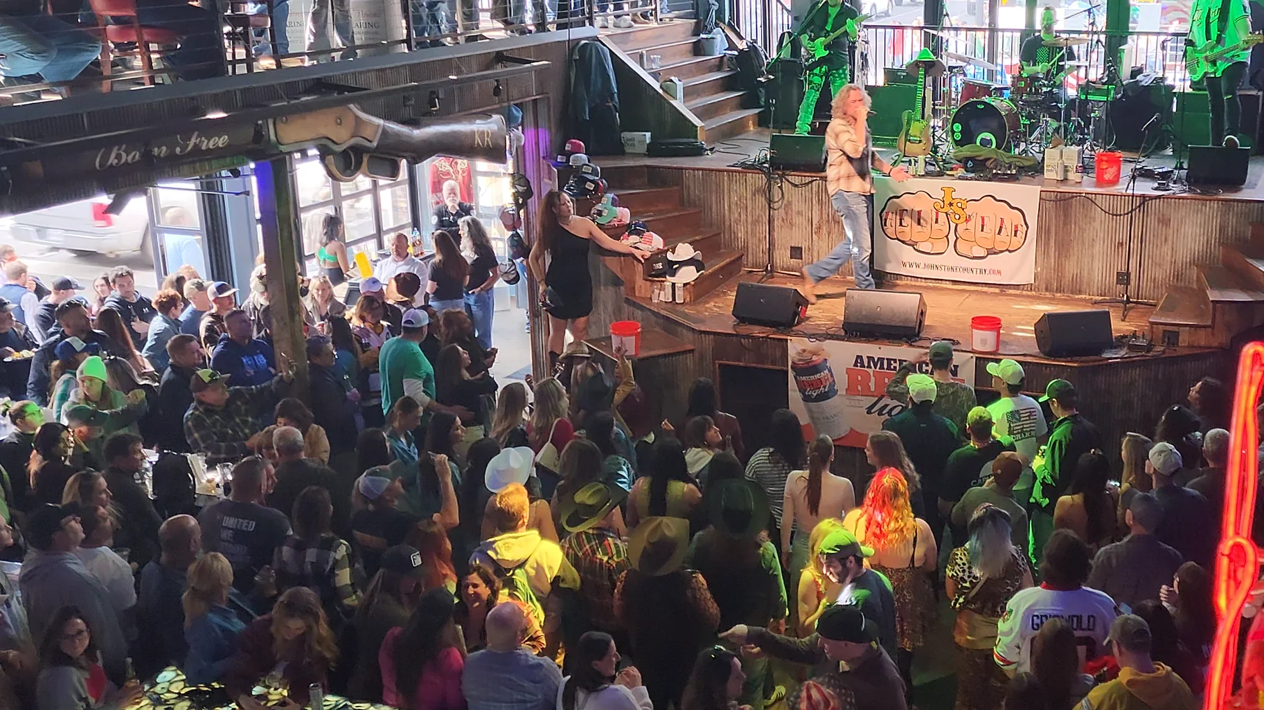 A daytime crowd inside a Lower Broadway honky tonk watching live music.