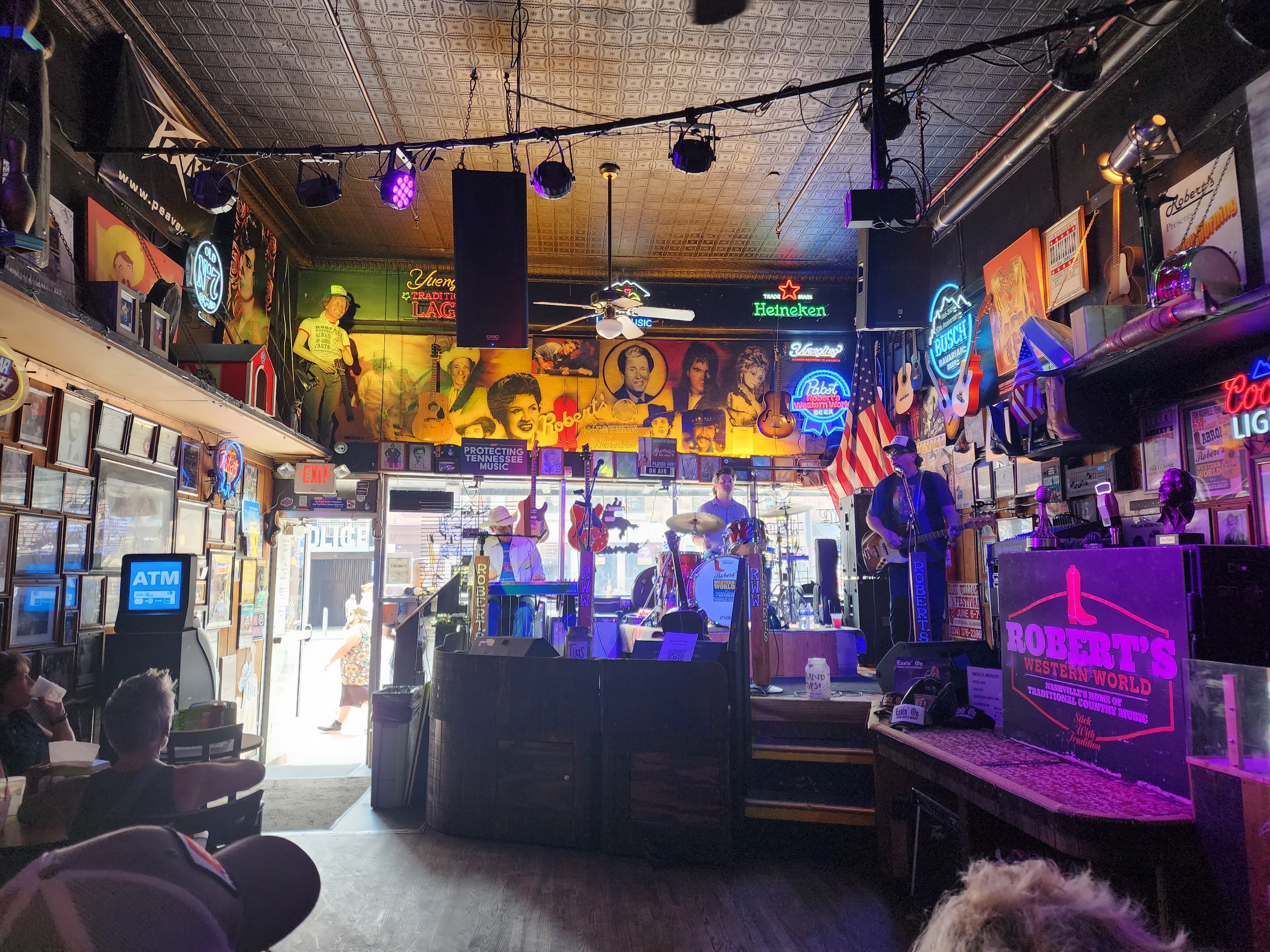 A band performs inside Robert's Western World with daylight coming through the Broadway entrance.