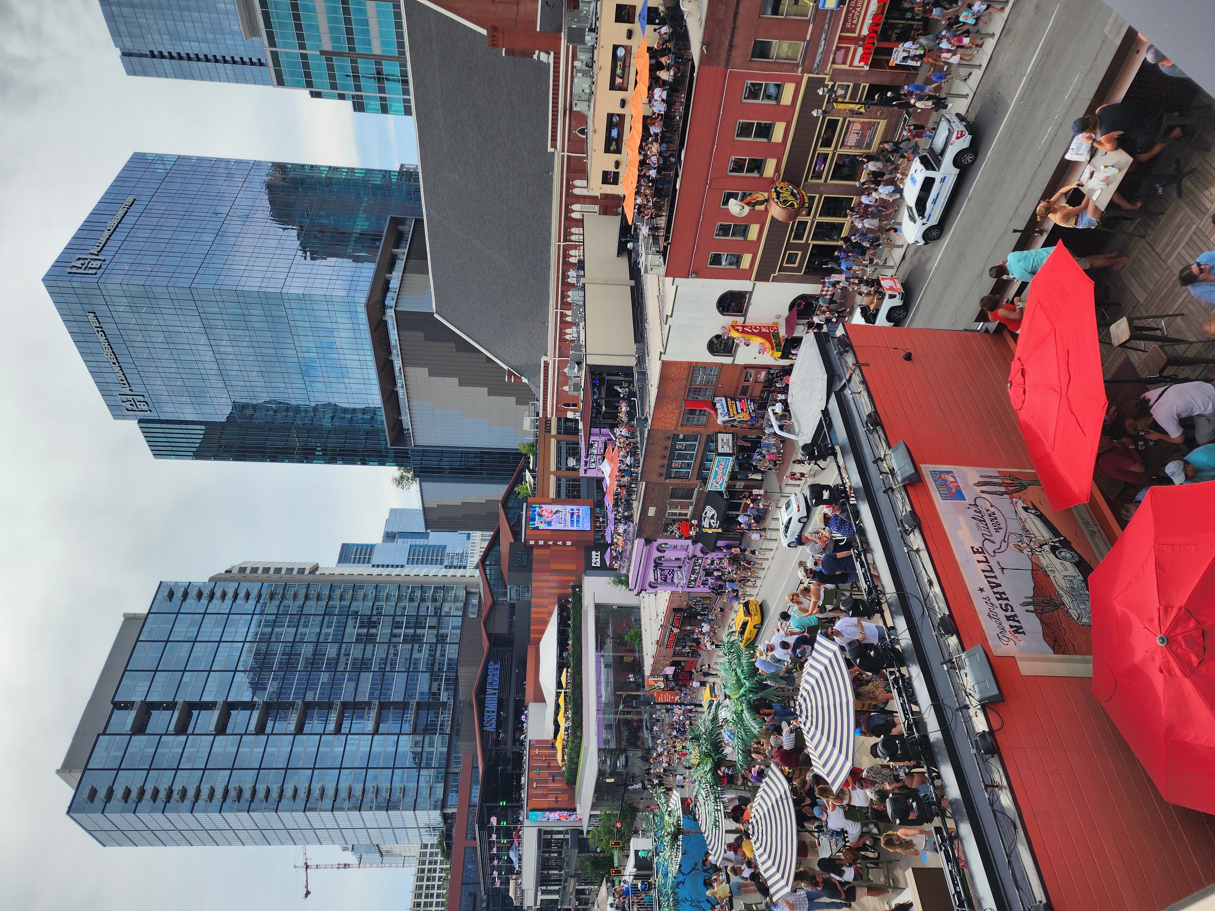 Rooftop terraces overlook Broadway, with the Ryman and Assembly Food Hall visible beyond.