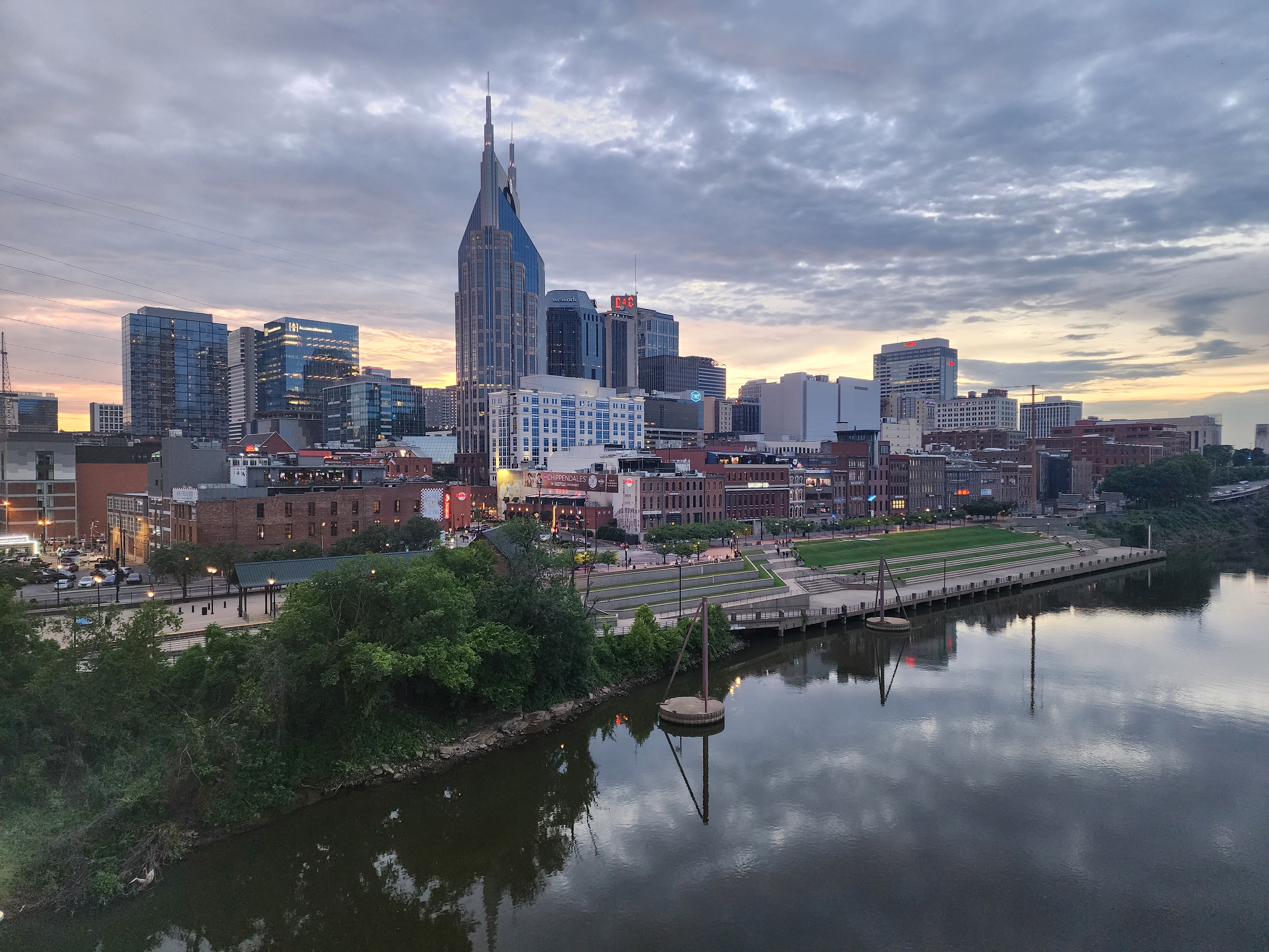 Downtown Nashville skyline and riverfront at sunset.
