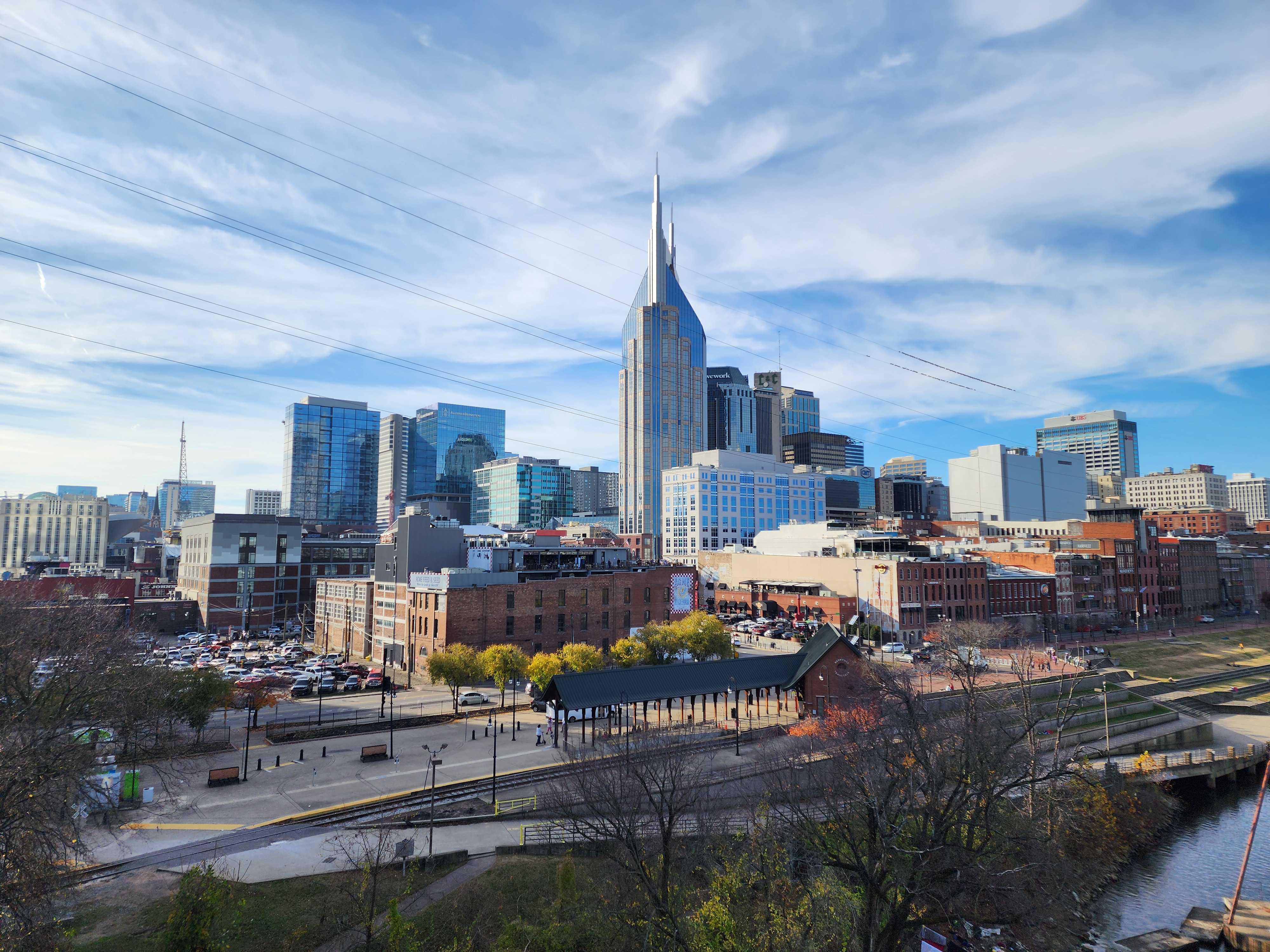 The downtown Nashville skyline and riverfront in daylight.