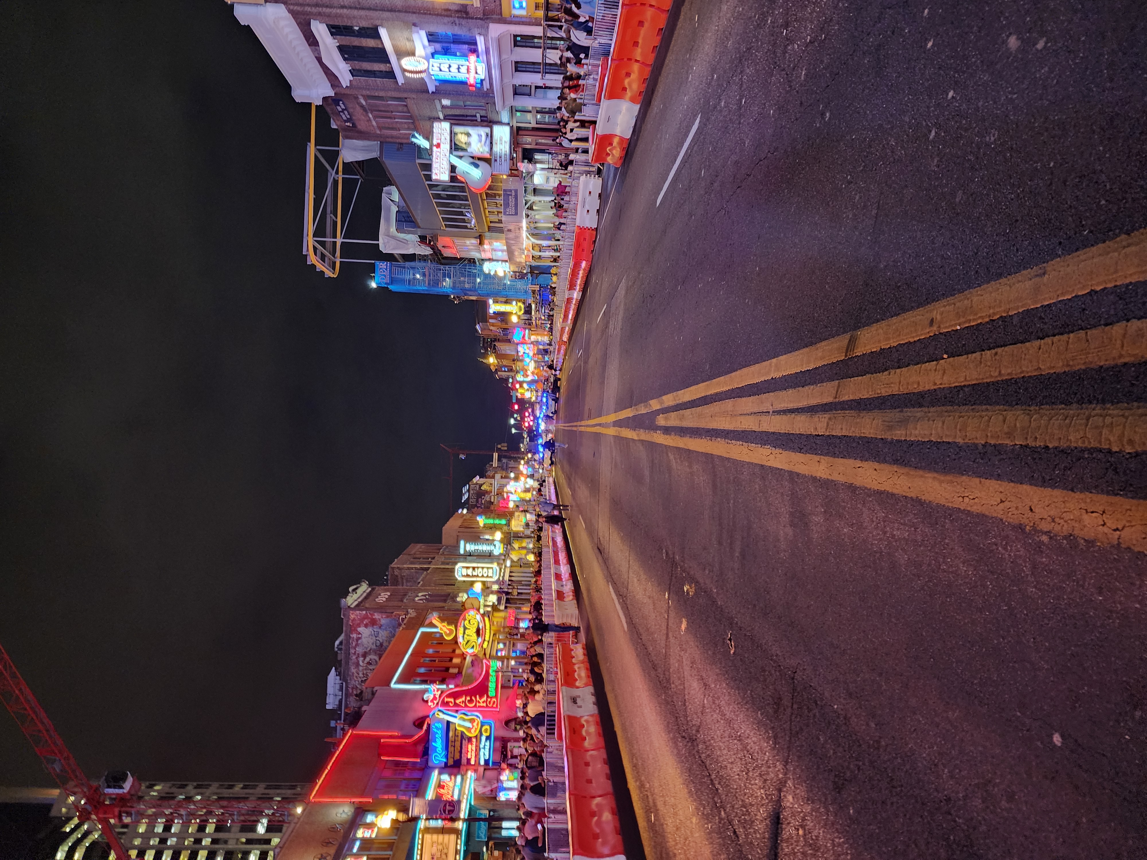 A comparatively quiet Lower Broadway roadway at night.