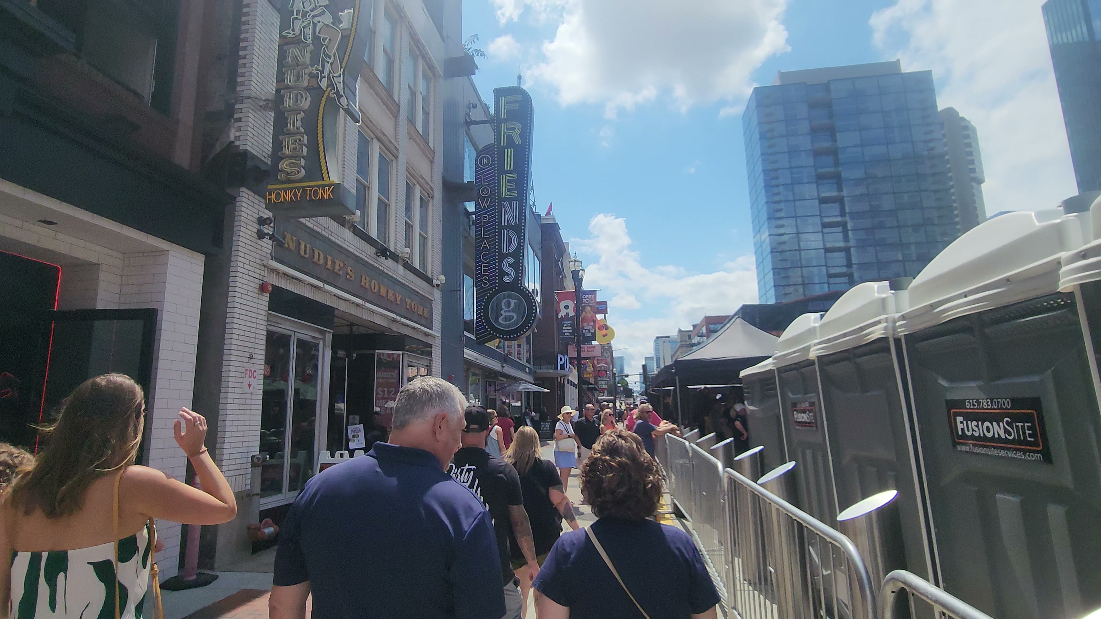Lower Broadway on a clear sunny day in warm weather.