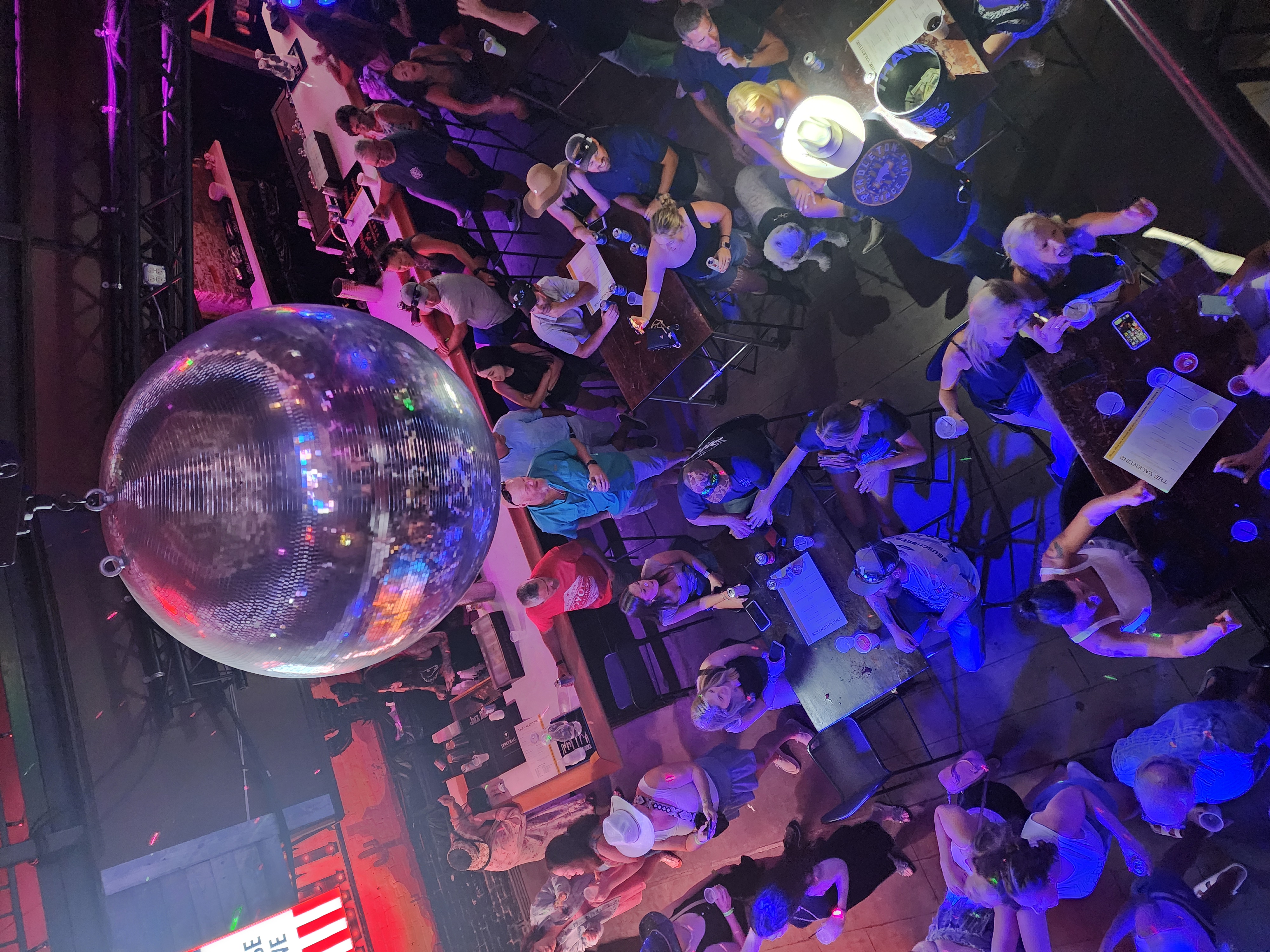 A dance-floor crowd gathered beneath a large mirrored ball in Nashville.