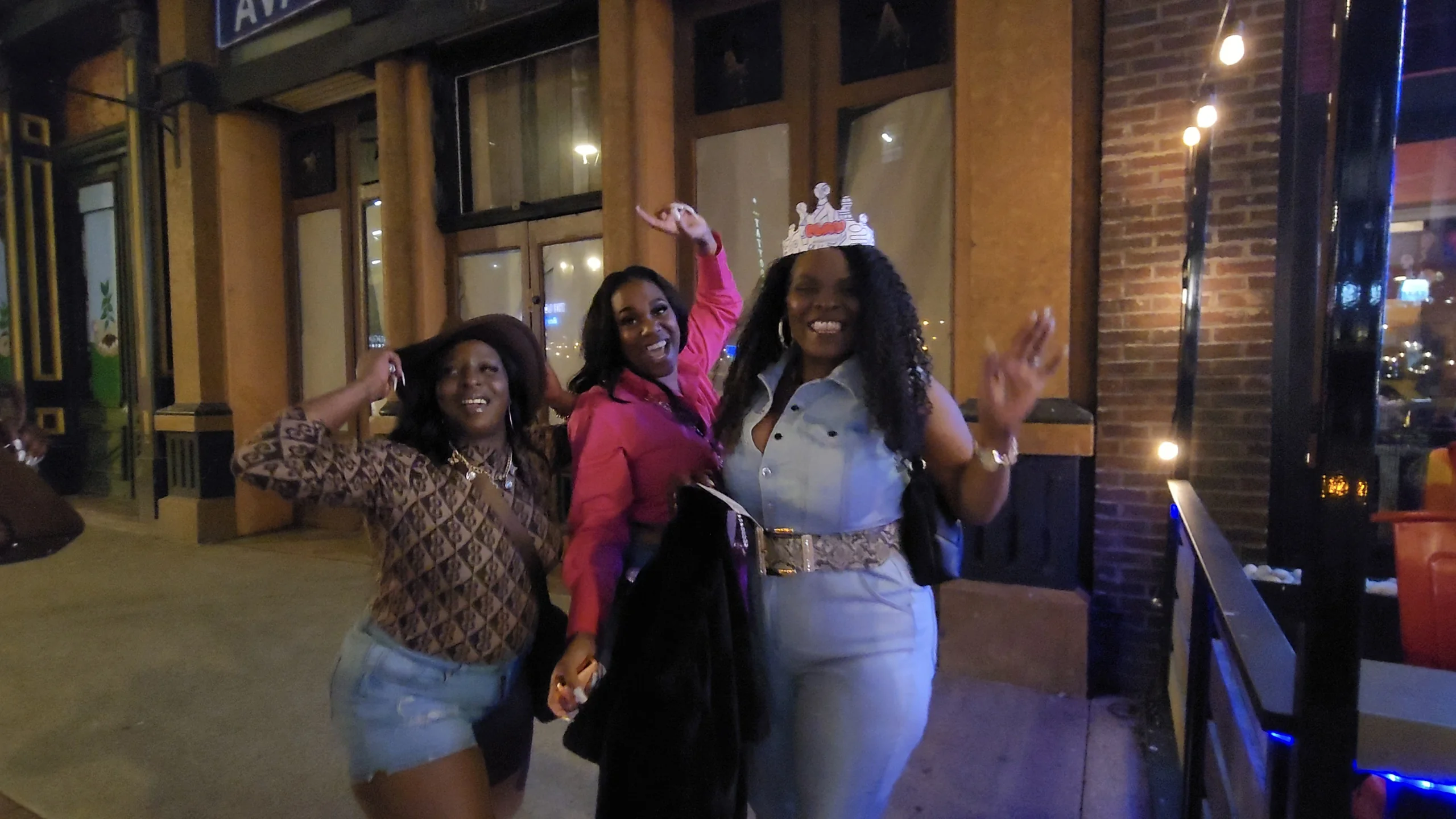 Three women dressed for a night out on Broadway in Nashville.